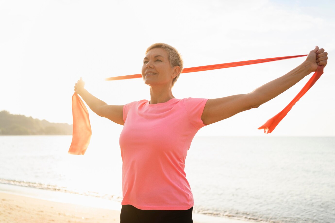 senior woman with elastic rope beach 23 2148685690