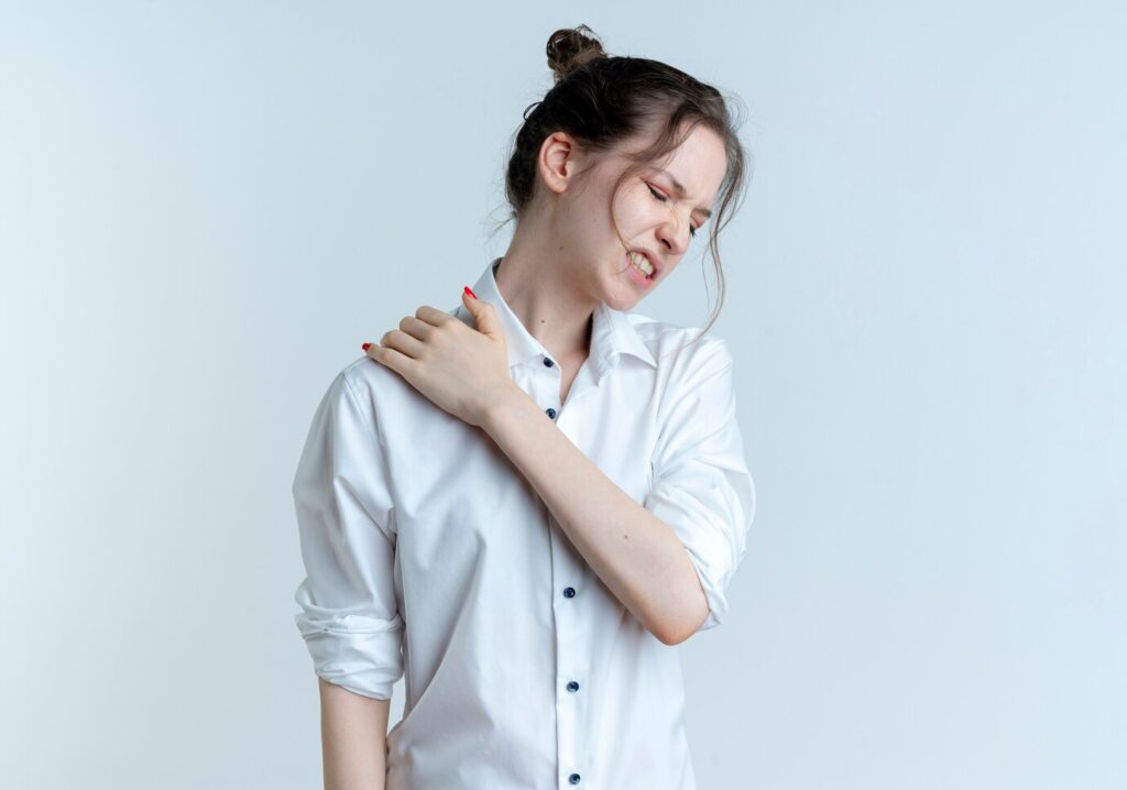 young aching blonde russian girl holds shoulder isolated white space with copy space 141793 60145