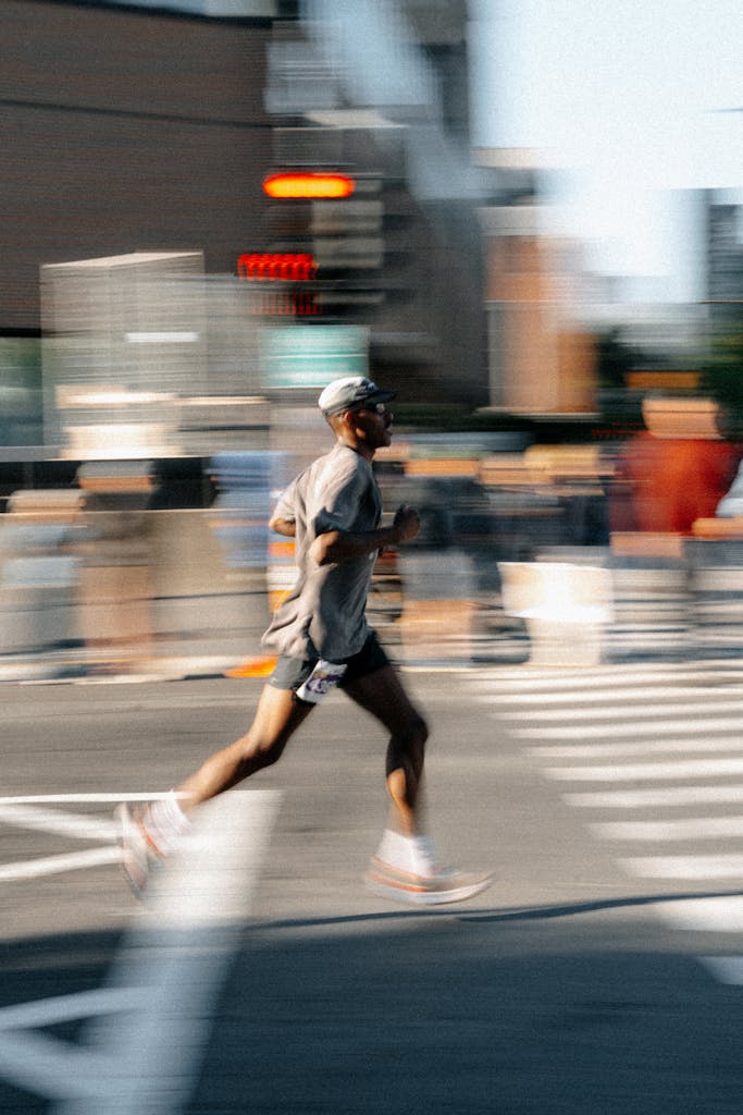 Blurred motion shot of a runner crossing the street in Montréal, capturing urban energy and speed.